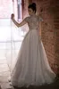 2020 Modest Keyhole High Neck Manica corta Una linea Abiti da sera Applique in pizzo Perline di cristallo Ruffles Abiti formali Sweep Train Abito da festa