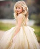 Högkvalitativa blomma tjejer klänningar sparkly guld sequins elfenben kjol barn långa formella bröllopsfestklänningar ärmlös öppen rygg