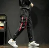 Printemps nouveau pantalon décontracté concepteur japonais petits pieds amples personnalisés avec des autocollants blancs et rouges pantalon grande taille