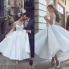 Abiti da sposa eleganti di lunghezza del tè con una linea drappeggiata sexy senza spalline senza schienale eleganti abiti da sposa corti abiti da sposa applique in pizzo