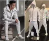 Tute sportive da uomo alla moda Tute bianche nere Tute giacca con cappuccio Uomo / donna Giacca a vento Cerniera abbigliamento sportivo Moda felpa con cappuccio ZNE giacca + pantalone