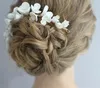 結婚式のブライダルホワイトセラミックの花のヘッドバンドの櫛のクリスタルラインストーン花の冠Tiarasヘアアクセサリージュエリーヘッドピースプロム韓国のヘアバンドチャーム