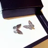 女性の結婚式のパーティーイヤリングジュエリーギフト蝶のための最新の白い立方体ジルコニア蝶のイヤリング