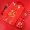 Sac en plastique rouge avec poignée, sacs cadeaux en papier pour cadeaux de fête de mariage, fournitures de pochette à vent chinoise, prix de gros de haute qualité