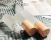 100pcs 5ml 10ml Frosted Clear Glass Roll On Bottle with Wood Grain Plastic Cap Stainless Steel Metal Roller Ball Essential Oil 1 2 3 ml Vials by free express