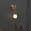 Nordisk personlighet kreativ vardagsrum metall vägglampa mode modern minimalistisk modell säng glas vägg lampa sovrum