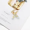 2020 High-end Custom Crystal Epoxy Letter Golden Keychain Star Fur Ball Bag Pandent Creativity Key Ring Oem Number Keychains