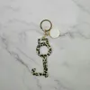 Europeisk och amerikansk exportkälla Keychain Anti-Epidemic Door Opener Oil Drop Pendant