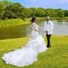 2022 Långt tåg Afrikanska sjöjungfru bröllopsklänningar Brudklänningar Ruffle Tiered Skirt Lace Full Sleeve Kapell Sexig Illusion Bride Dress Appliques Vestidos de Novia