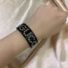 La nueva pulsera de moda abierta con estrella de diamantes de resina, pulsera salvaje opcional de dos colores en blanco y negro 8411085