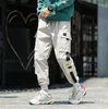 Diseñador de la marca Spring Hip Hop Joggers Hombres Pantalones Harem Negros Cintas multibolsillos Hombre Pantalones de chándal Streetwear Casual Mens Cargo Pants278V