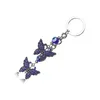 Porte-clés porte-bonheur mauvais œil, breloques papillon pendentif pompon, porte-clés de voiture en cristal pour femmes, bijoux à la mode, cadeaux 237y