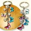 Porte-clés papillon coloré à la mode, sac de téléphone, sac d'école, pendentif papillon en perle, porte-clés en alliage, cadeaux pour femmes