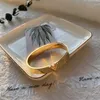 Pulseira de aço inoxidável inspirada em marca famosa banhada a ouro