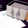 Precioso lindo diamante circón torcido arco aretes moda diseñador de lujo araña cuelga clip en aretes para mujeres niñas estudiantes