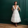 ビンテージ素朴なショートAラインのウェディングドレス深いVネックオープンバックシンプルなブライダルガウンティーレングスチュールボービーチの花嫁のウェディングドレス