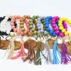 Moda Pulseras de cuentas de madera Borla de haya Llavero Colgante de fiesta Pulsera de cuero Llavero de mujer Llaveros de mujer Disco de muñeca de madera Anillos de cuentas