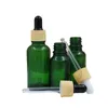 Puste Green Glass Refillable Butelka 5ml 10ml 15 ml 20 ml 30 ml 50 ml 100 ml Kontener opakowania Kosmetyczne Fałszywe drewno Plastikowe pokrywy Oleju Gumowe Fiolki