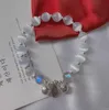 Lyxmode Naturlig pärla Lucky Bead Strängar Pärlarmband Brudberlocksmycken för kvinnor Dam Tjej Elastiskt armband Härliga smycken