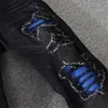 22SS Newst Design Jeans pour hommes avec des trous noirs Les patchs déchirés bleu foncé sont lavés pour les loisirs d'auto-culture européens américains