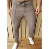 Mens sólido cores calças moda tendência zipper botões cordão esportes esportes lápis calças primavera macho linha plissada zíper calça magra ocasional