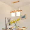 Lampada a sospensione da ristorante per uccelli con personalità nordica Lampadario a LED in vetro bianco a strisce lunghe in legno massello Lampada da studio per soggiorno a 2/3 teste