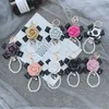 Art und Weise neuer Bowknot Camellia Keychain kreative Perlen-Ketten-PU-Leder-Rosen-Blumen-Tasche Auto Keychain Anhänger Zubehör