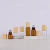 Factory Prijs Lege Amber Clear Glass Roller flessen voor Essentiële oliën Parfum Mini Roll-on Bottle met plastic houten korrelkap