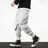 Грузовые брюки Мужчины Harem Joggers Брюки Мужчины Harajuku хип-хоп Уличная одежда Черные спортивные штаны Joggers мужские брюки негабаритные мужчины одежда H1223