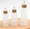 50ml 100ml 120ml platt axel frostat glas spray pump flaskor med bambu lock för hudvård serum lotion shampoo shower gel toalettartiklar sn6157