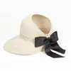 新しい夏の弓の帽子の空のトップハット女性の紫外線の帽子のカットアウトビーチの帽子女性サンキャップリボンニットラフィア