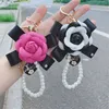 Art und Weise neuer Bowknot Camellia Keychain kreative Perlen-Ketten-PU-Leder-Rosen-Blumen-Tasche Auto Keychain Anhänger Zubehör