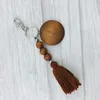 Le porte-clés en perles de bois perlé de commerce extérieur personnalisé peut imprimer un porte-clés pendentif rond et en coton