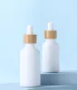 Garrafas de conta-gotas de porcelana branca vazia 10ml 15ml 20ml 30ml 50ml 100ml para óleos essenciais cosméticos com tampas de bambu