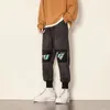 メンズパンツ到着男性ハーレムファッションジョガーカラープリント日本の街路壁ヒップホップルーススウェットパンツ男性ビッグサイズボトムス1