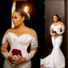 2022 Sexy African Arabic Mermaid Wedding Dresses Jewel Neck Illusion Crystal Beaded Long Sleeves Button Back Satin Court Train Plus Size Bridal Gowns