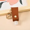 Commerce extérieur anti-épidémique petit artefact pendentif clé en cuir PU, pratique pour transporter la couverture de désinfectant pour les mains, multicolore en option