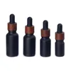 Black Frosted Glass Dropper Flaskor Essential Oil Perfumes Flaska med träkorn Plastlock 5 ml till 100 ml