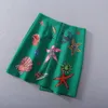 Vêtements pour femmes européennes et américaines 2021 Le nouveau printemps Starfish imprimé bouton perlé Jupe verte à la mode