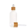 Flacon compte-gouttes en verre transparent givré avec couvercle en bambou Verres d'emballage cosmétique en bambou Bouteilles d'huile essentielle
