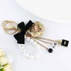 Accessoires de luxe camélia dégoulinants d'huile, sac à chaîne de perles avec nœud exquis, pochette porte-clés pour filles, cadeau Llaveros YS072