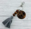 Personnalité de la mode transfrontalière perlée en bois porte-clés en bois rond imprimable disque pompon clé pendentif