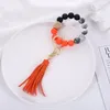 35 colori Bracciale con perline in acrilico Portachiavi Favore di partito Braccialetti con perline di legno Portachiavi Pu nappa anti perdita Portachiavi da polso T9I001647