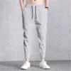 Mens fasta färger sportbyxor mode trend fitness mitten midja is silke sweatpants vår manlig ny dragsko elasticitet springa byxor