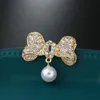 Elegant Gold Color Rhinestone Brooch Bowknot Simulated Pearl Lapel Pin For Women Simple Dress Coat Cardigan Wedding Jewelry Gift