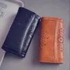 財布女性中空渤海革女性カジュアルハンドバッグレディーソリッドクラッチバッグ携帯電話カードホルダー長い財布カップル2021