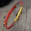 チャームブレスレットチベットの仏教の手作りノット糸不規則なビーズ赤の黒ロープ引っ張りブレスレットの女性Y3T9