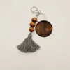 Porte-clés en perles de bois pour cadeaux de fête, avec copeaux de bois ronds et pompon en coton, pendentif, Logo personnalisé par Sublimation