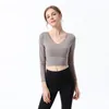 Tuta da donna Top T-shirt Abbigliamento da donna Abbigliamento da yoga Fitness Sport Bellezza Indietro Reggiseno elasticizzato a maniche lunghe ad asciugatura rapida Biancheria intima T-shirt antiurto