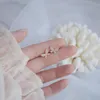 Stud coreano venta joyería de moda cobre incrustaciones circón mariposa perla borla oreja Clip para hueso asimétrico pendientes femeninos